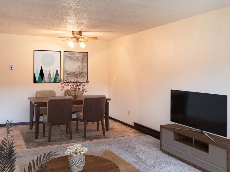 a living room and dining room with a table and a television. Fargo, ND Patricia Ann Apartments